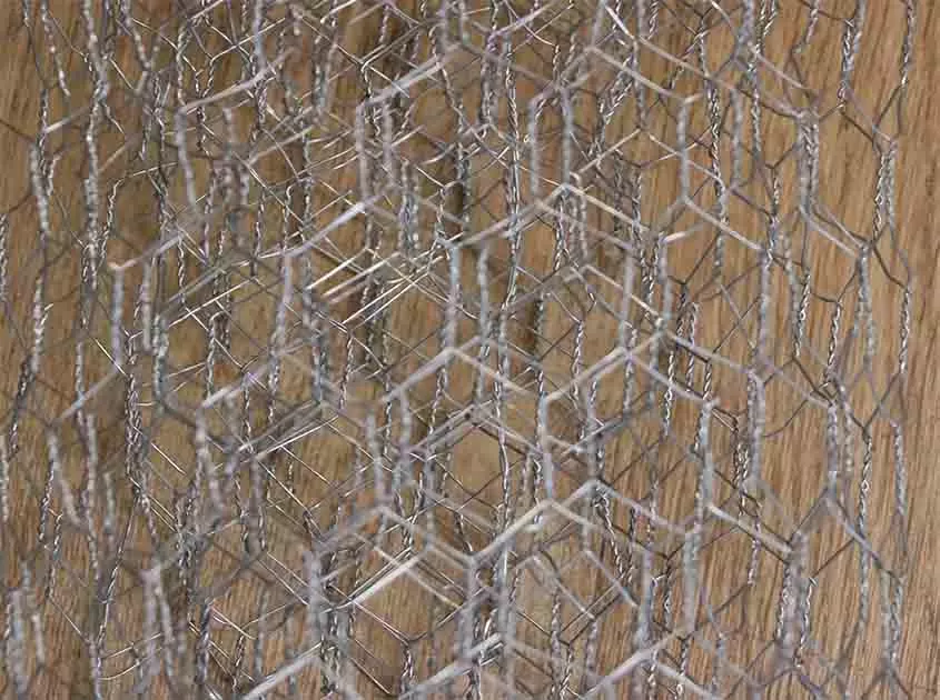 What are the installation considerations for chicken wire mesh on different surfaces